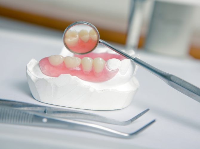 Dentist tools with acrylic denture